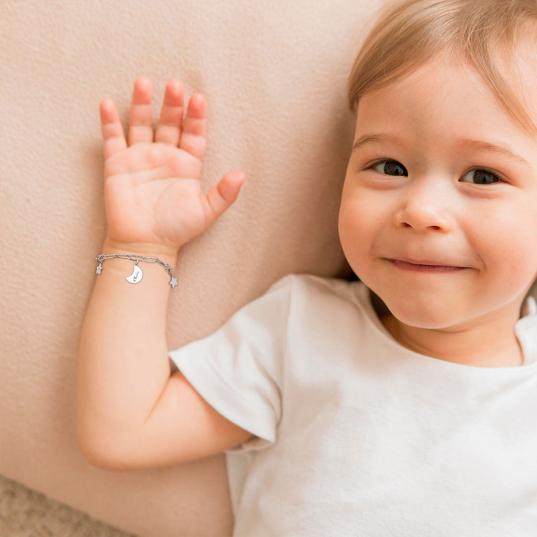 Silver Star and Moon Custom Baby Name Bracelet Worn on the litter one's hand