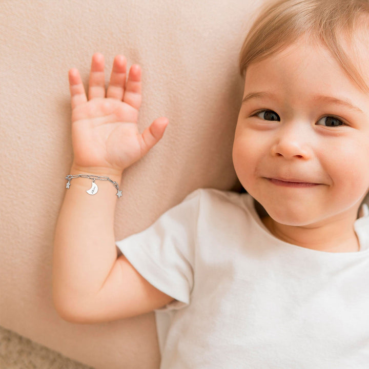 Silver Star and Moon Custom Baby Name Bracelet Worn on the litter one's hand