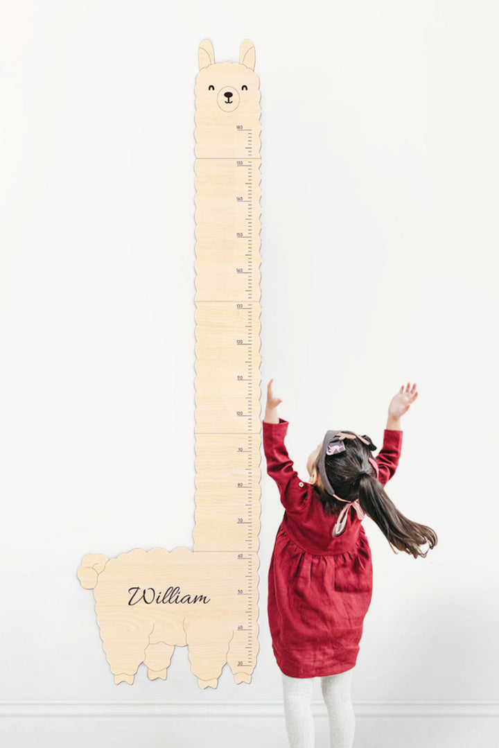 Personalized Wooden Alpaca Baby Growth Chart and a Child